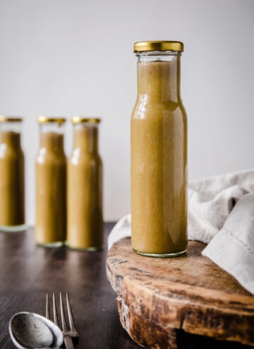 A bottle of Green tomato ketchup on a wooden board