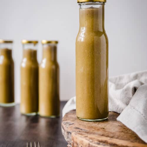 A bottle of Green tomato ketchup on a wooden board
