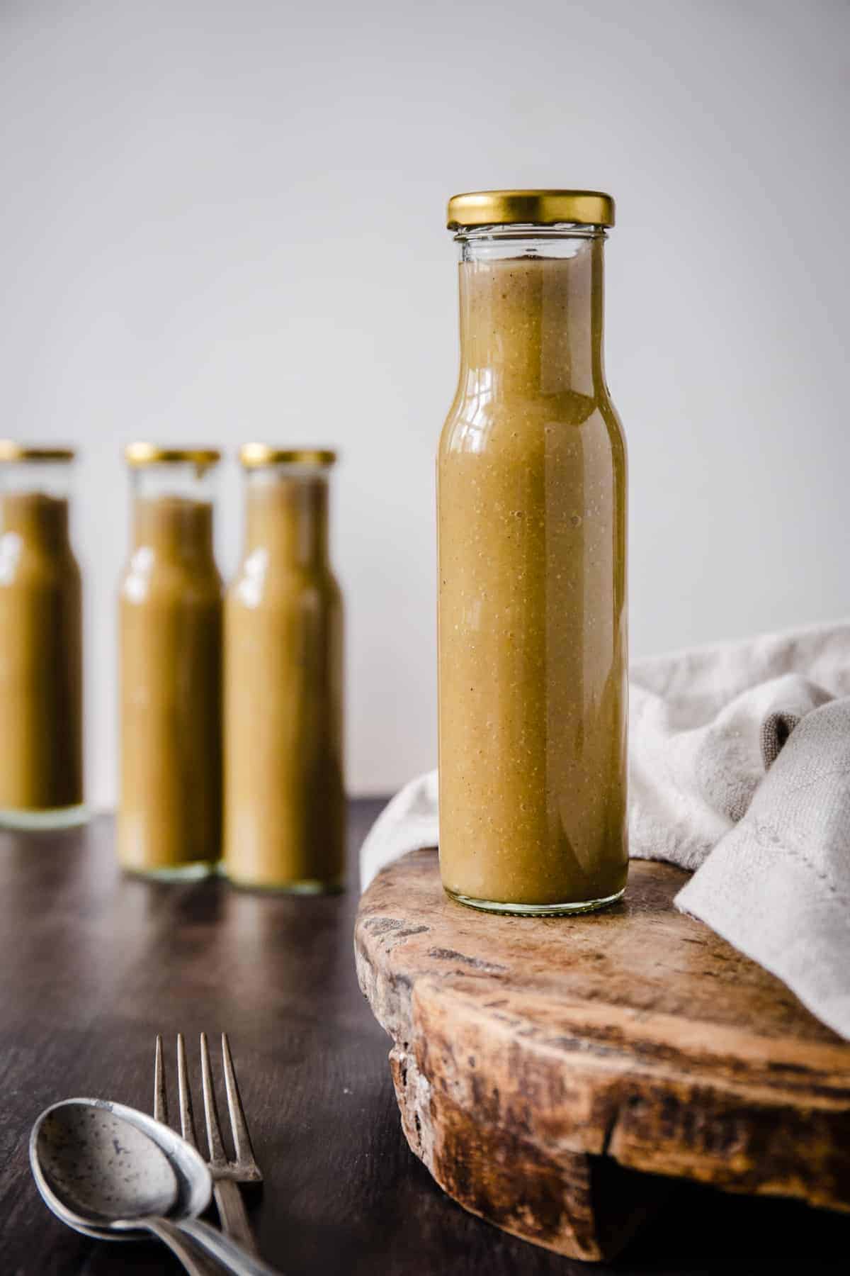 A bottle of Green tomato ketchup on a wooden board