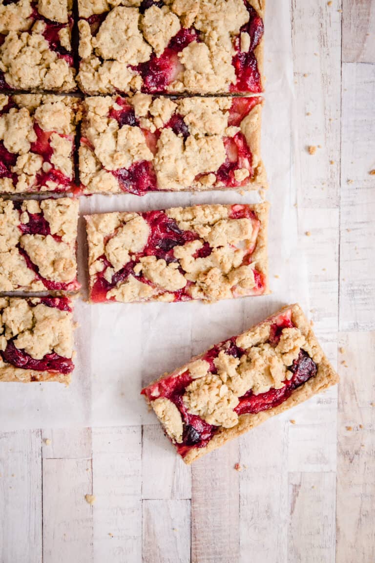 overhead of apple cranberry bars on a white surface