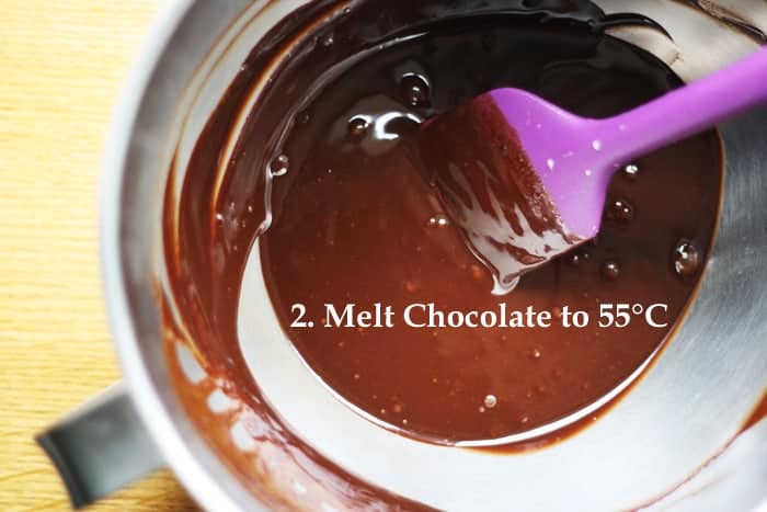 A cup of melted chocolate with the words Melt Chocolate to 55 degrees.