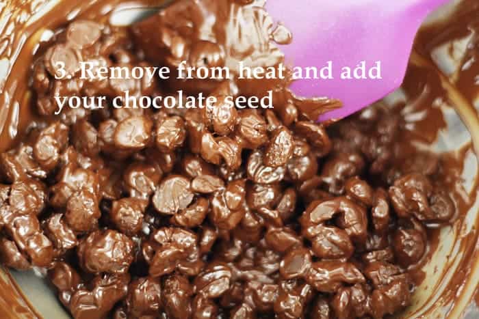 A close up of chocolate with words Remove from heat and add your chocolate seed