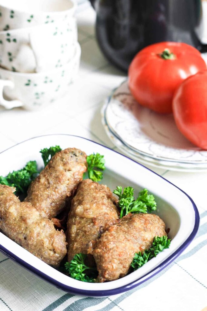 An oven proof dish filled with Chicken Thyme and Fennel Sausages