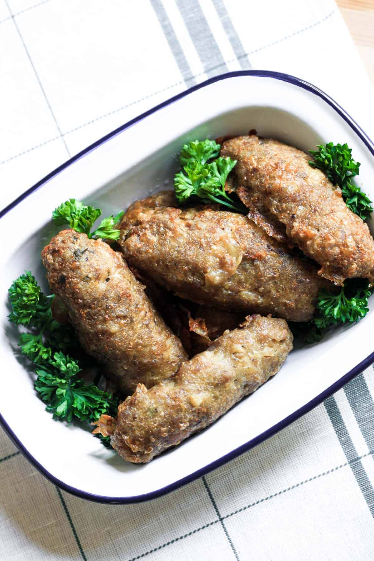 An oven proof dish filled with Chicken Thyme and Fennel Sausages