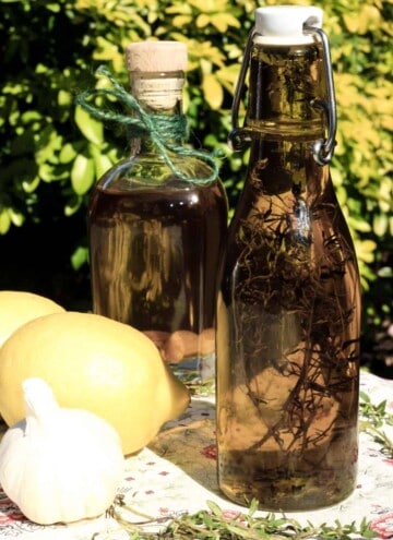 A glass bottle of olive oil on a table