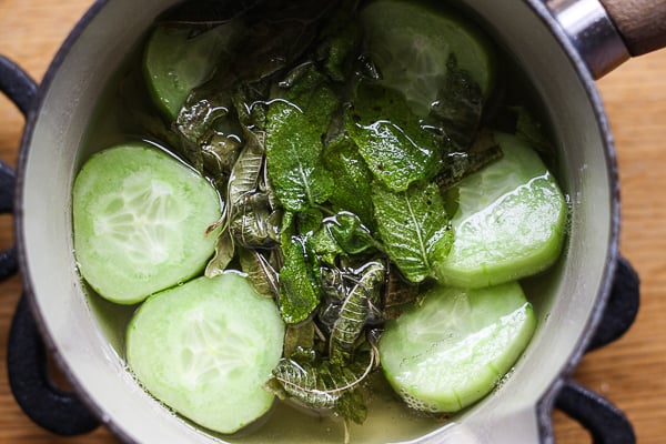 A saucepan of sugar syrup with cucumber and mint 