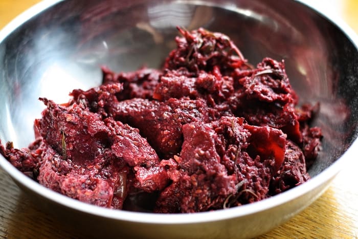 A close up of a bowl of blackberry pulp