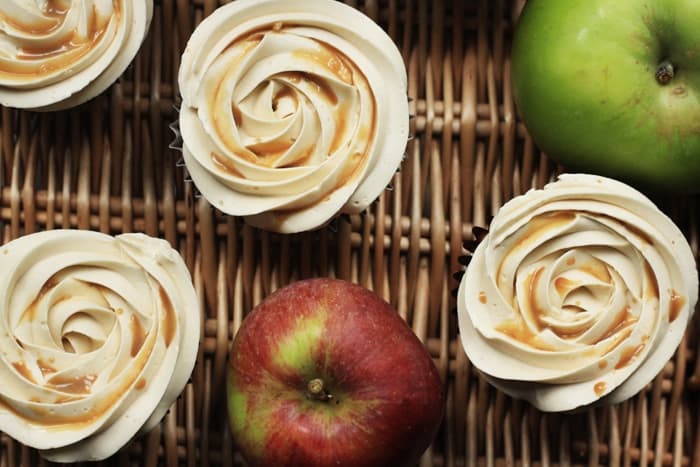 toffee apple cupcakes on wicker basket next to apples