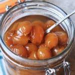 jar of pickled mirabelles on a table