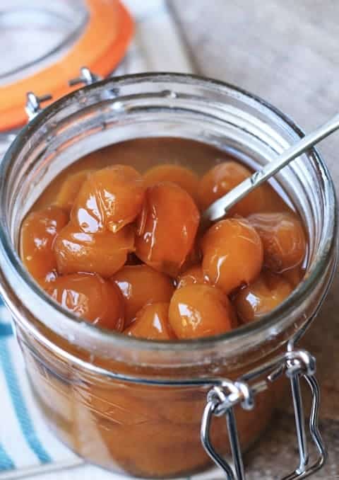 jar of pickled mirabelles on a table