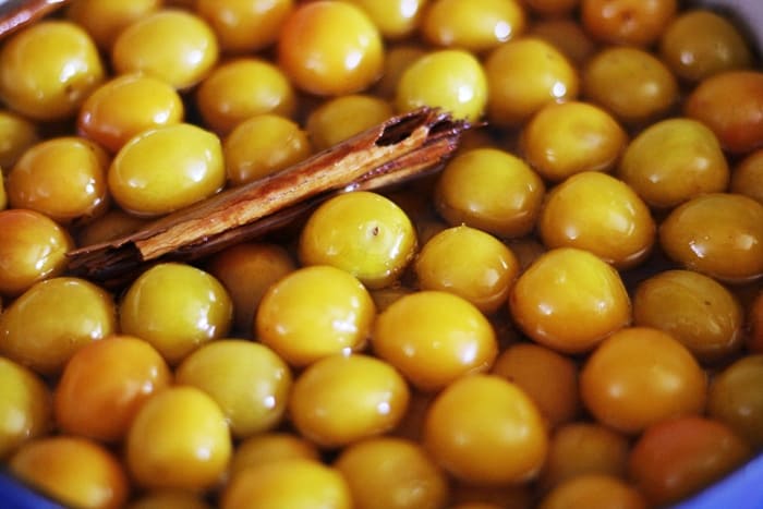 A pile of mirabelles in pickling juice and cinnamon