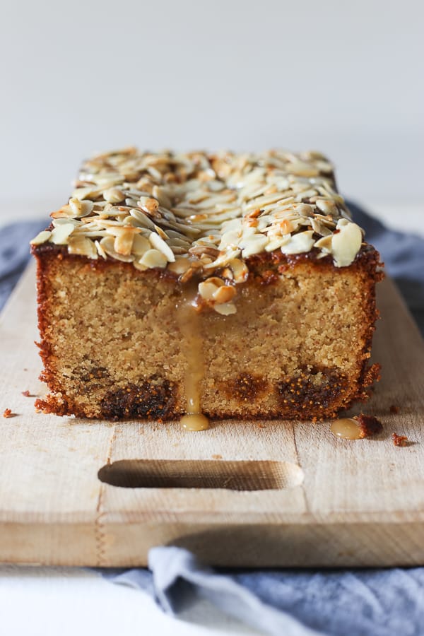 A fig cake sitting on top of a wooden cutting board