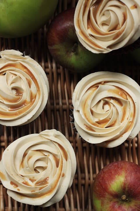 toffee apple cupcakes on wicker basket next to apples