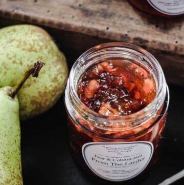 Pear jam in a jar next to pears