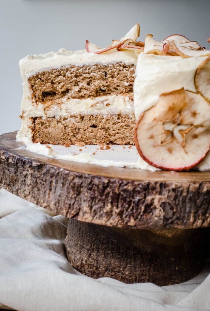 Close up of a cut Apple and Cinnamon Cake with Salted Caramel Cream Cheese Buttercream