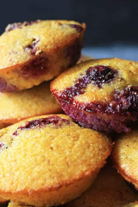 A close up of blueberry cornbread muffins