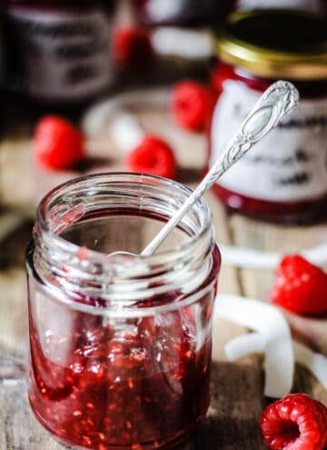 A jar of Raspberry Coconut Jam with a spoon