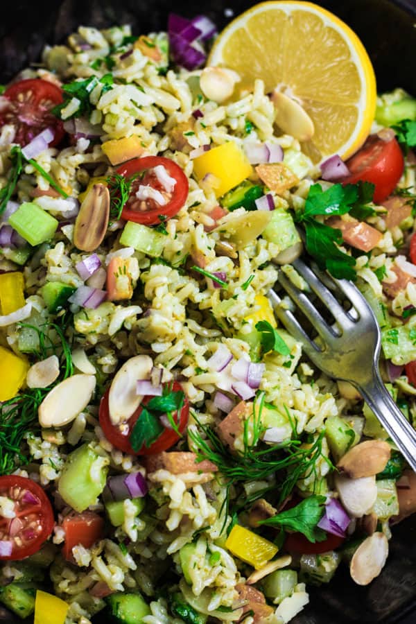 close up of simple brown rice salad with a fork