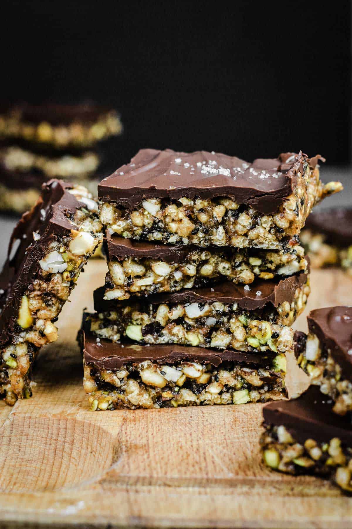 Side view of stack of No-Bake Chocolate Salted Energy Bars on a wooden board