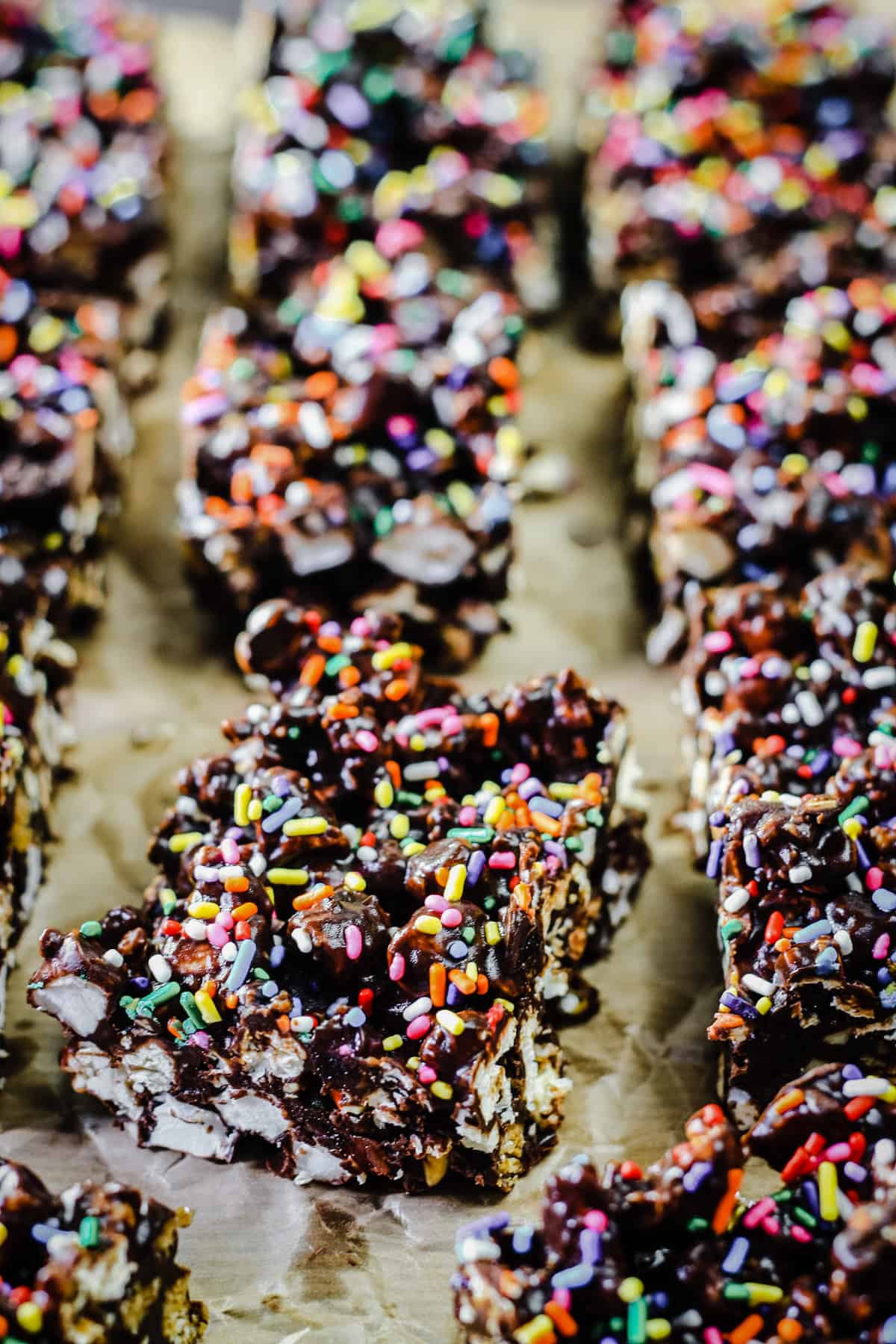 Ultimate Popcorn Rocky Road lined up on baking parchment