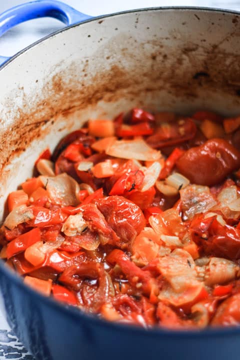 tomato sauce ingredients cooking in a pan