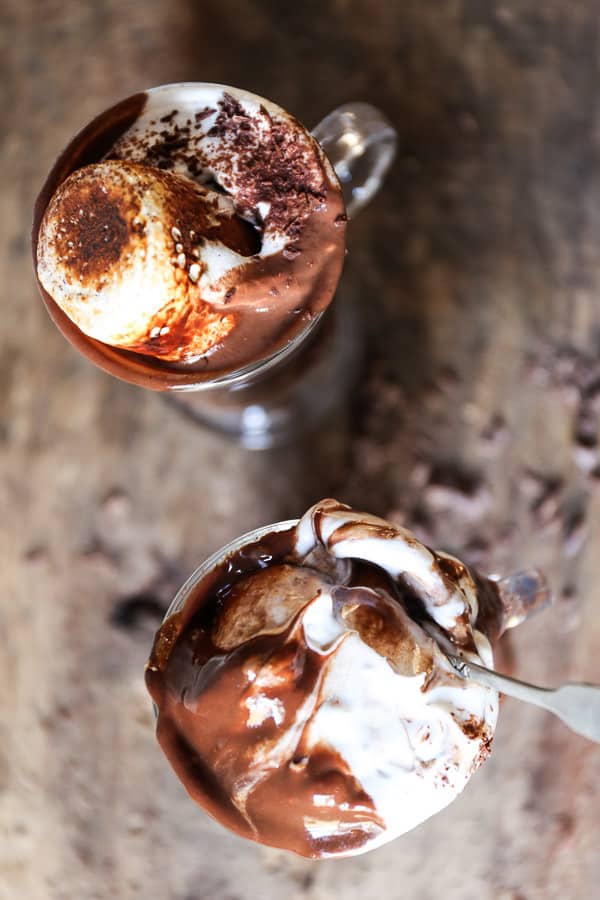 glasses of hot chocolate on a table with marshmallow from above