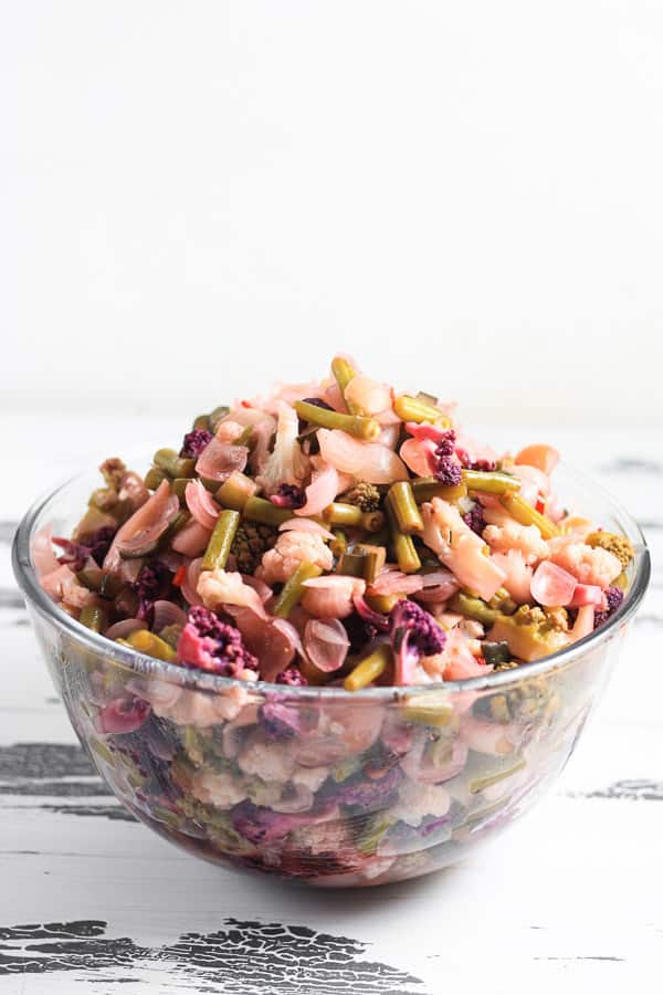 A bowl of piccalilli vegetables brining