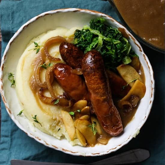 Warm and comforting roasted sausages on a mound of brown buttered mashed potato, thickly ladelled with apple cider onion gravy and adorned with sweetly salted caramelised cinnamon granny smiths