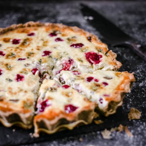 Stilton, Chestnut and Cranberry Tart with a slice taken out