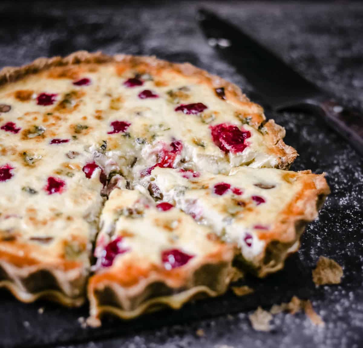 Stilton, Chestnut and Cranberry Tart with a slice taken out