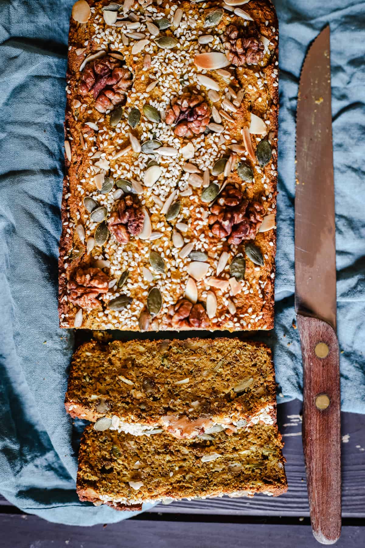 Sliced loaf of Happiness Bread on blue linen napkin