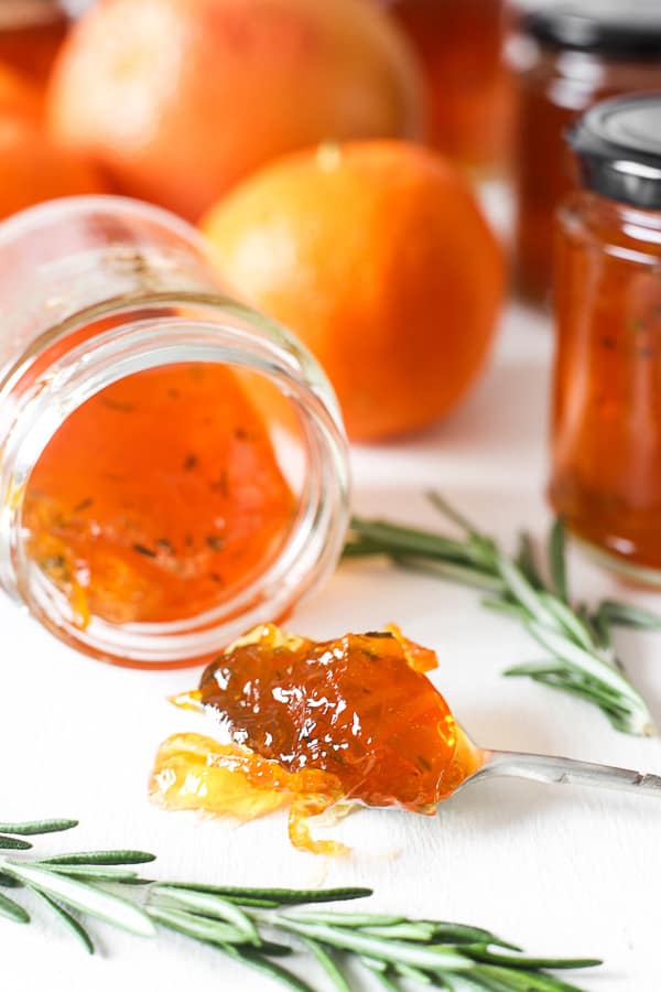 jar of marmalade on its side. spoon of jam in front