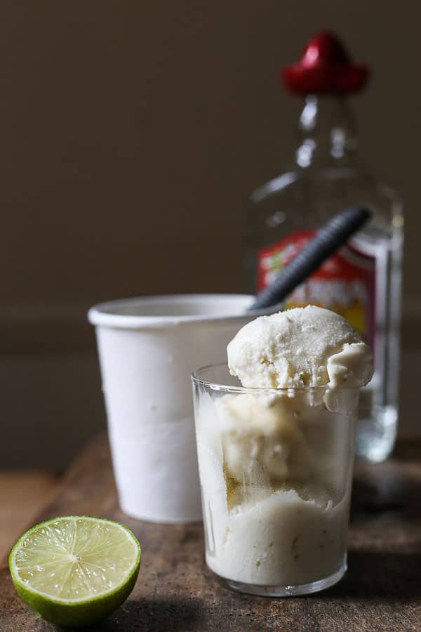 close up of ice cream in a glass in front of tub of ice cream