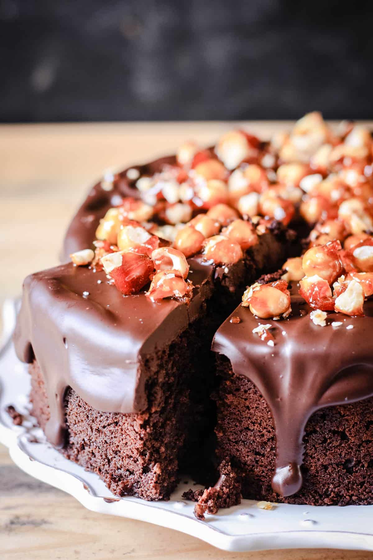 Decadent Chocolate Hazelnut Cake on a plate with a slice cut