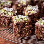 Flourless Chocolate Pistachio Coconut Slice on a wire rack.