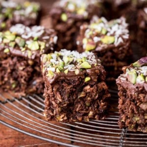 Flourless Chocolate Pistachio Coconut Slice on a wire rack.