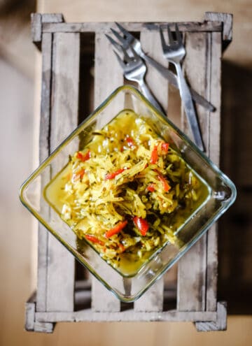 Courgette Relish on a wooden box with forks