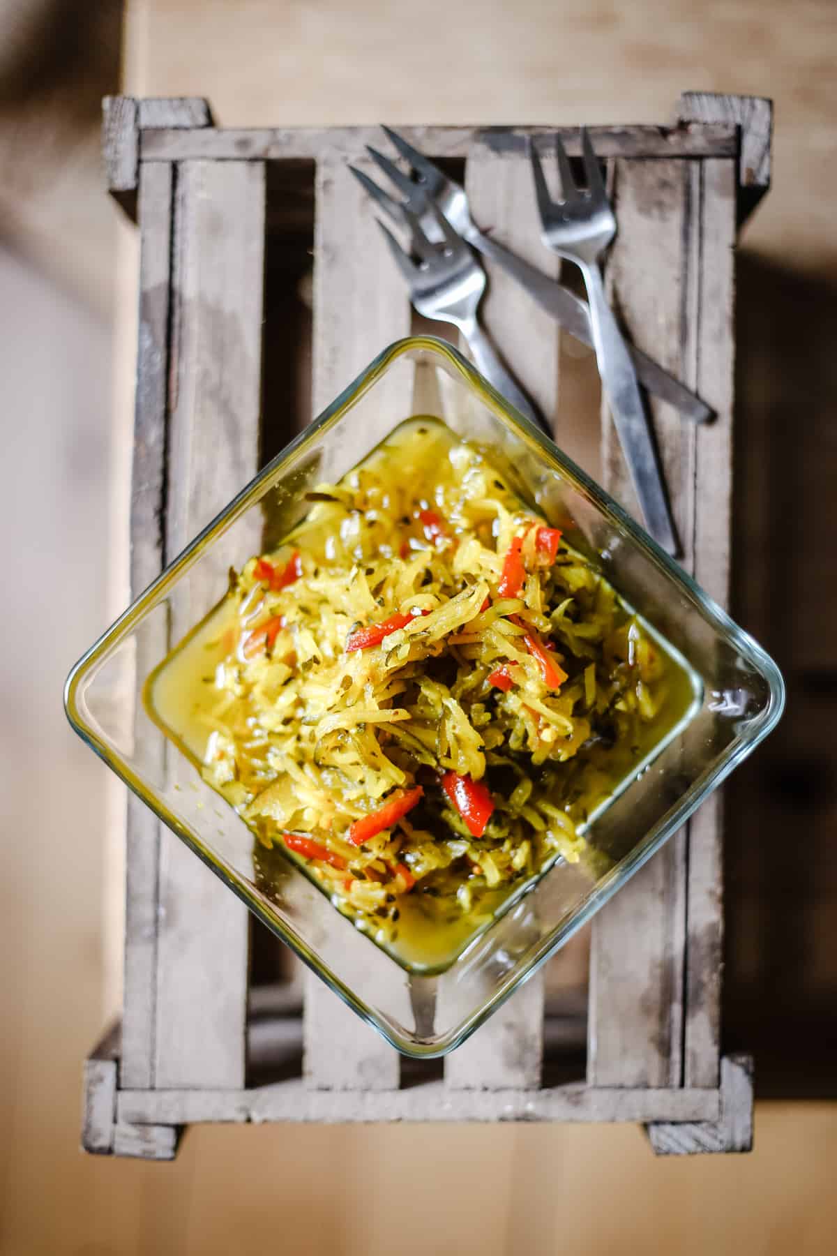 Courgette Relish on a wooden box with forks