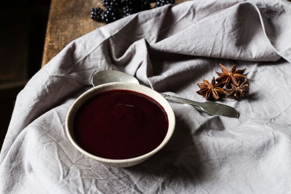 Blackberry Hoisin Sauce in bowl with spoon on tablecloth