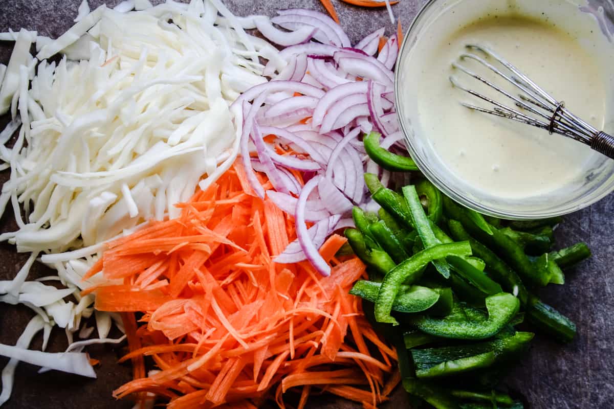 shredded vegetables for homemade coleslaw with dressing on the side