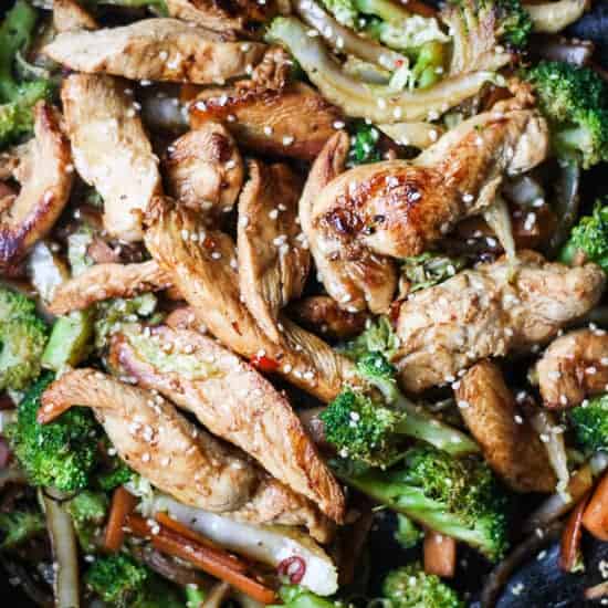A plate of stir fry chicken with broccoli