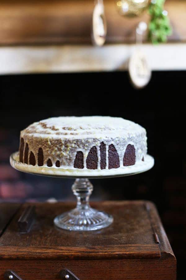 cake on cake stand on top of a wooden table