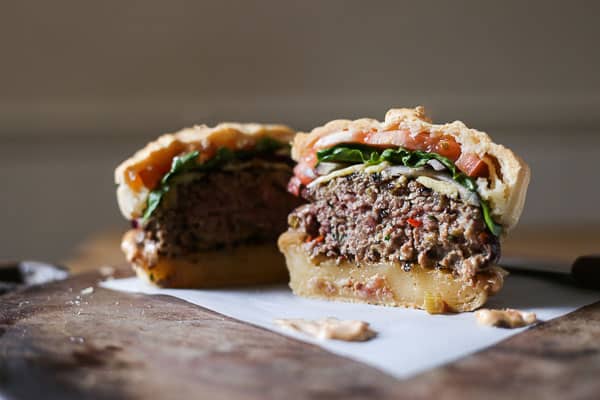 A halved burger on a wooden board