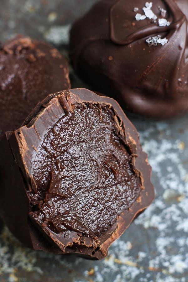 A close up of a chocolate truffle cut in half