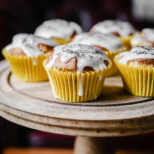 Lemon and Poppy Seed Muffins on a wooden cake stand