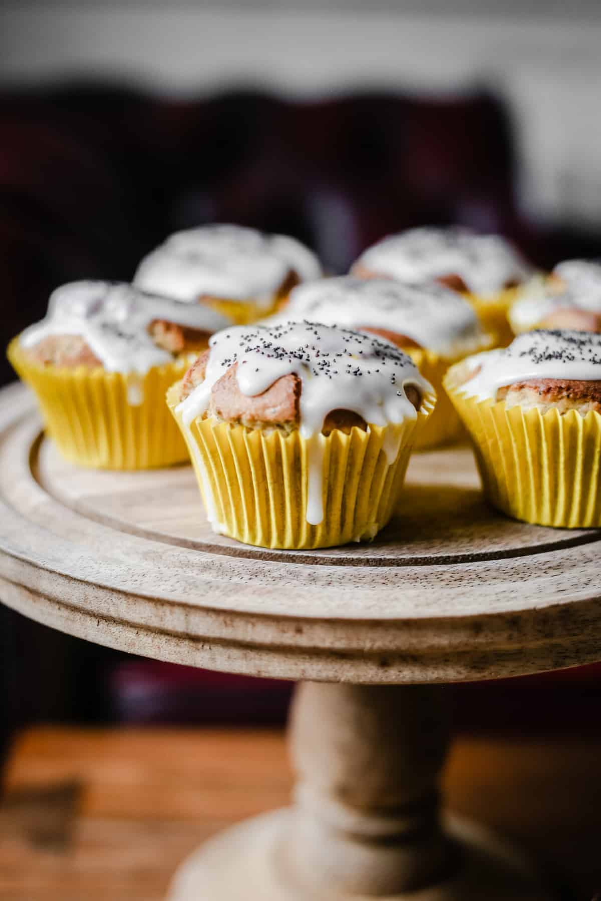 Lemon and Poppy Seed Muffins on a wooden cake stand