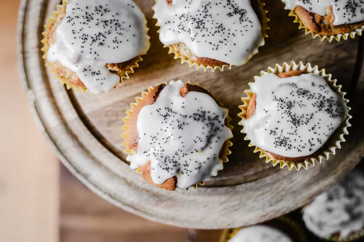 Lemon and Poppy Seed Muffins on a wooden cake stand