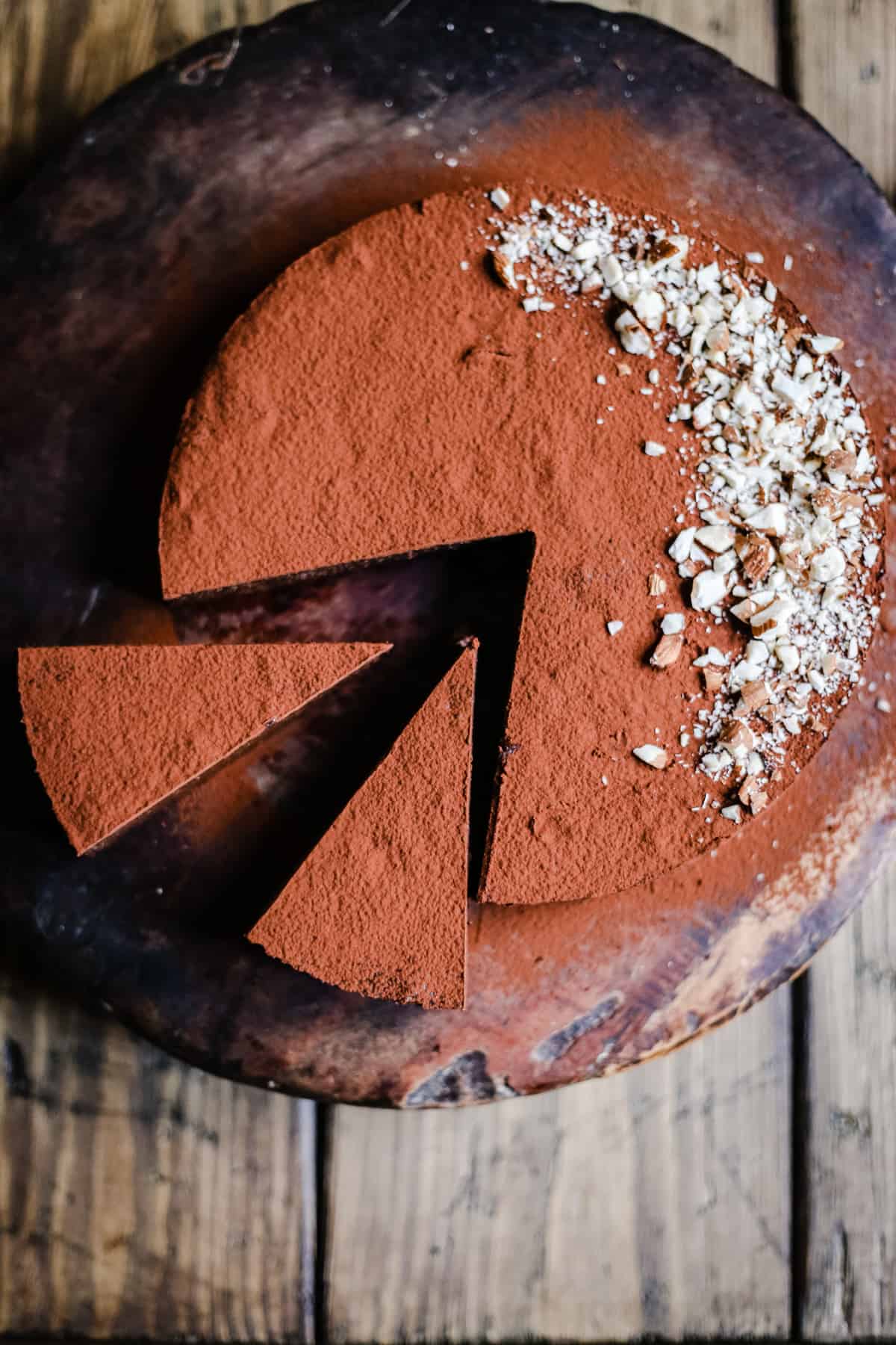 Sweet Potato Chocolate Truffle Torte cut into slices on wooden board