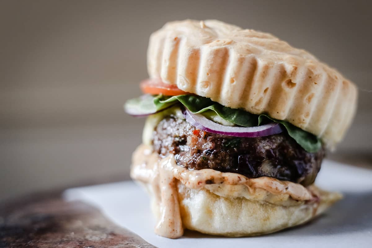 A close up of a burger on a plate