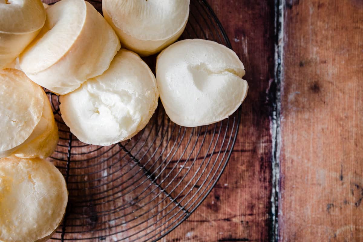 Cheese Bread Rolls on a wire rack on a wooden table